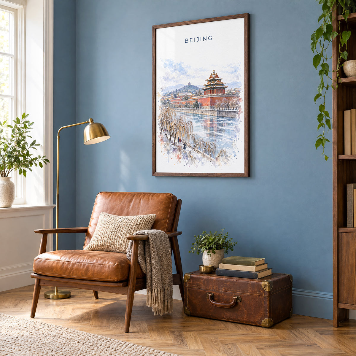 Beijing watercolor print in a walnut frame on a blue wall above a leather armchair in a reading nook
