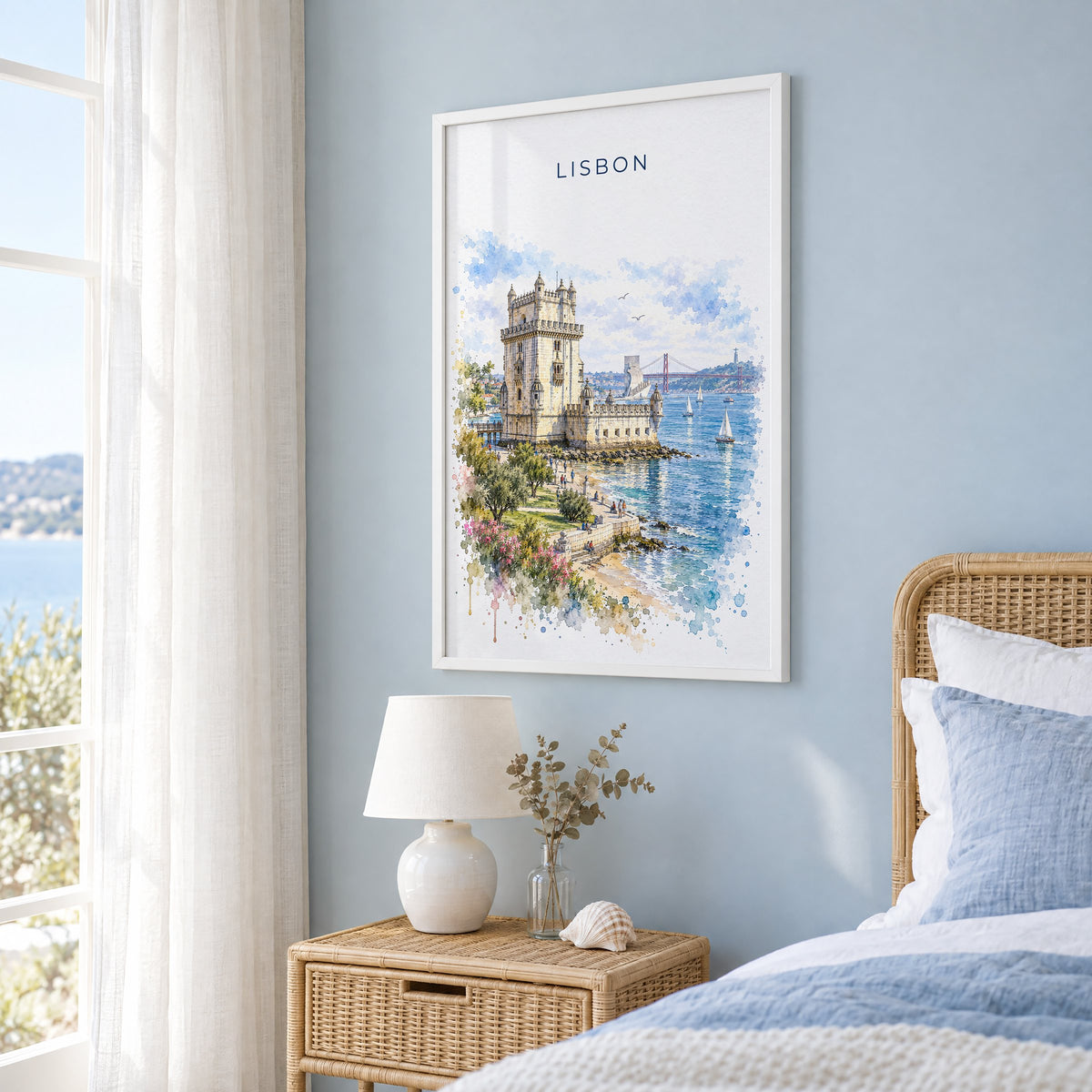 Belém Tower watercolor print in a white frame on a pale blue wall beside a rattan bed in a coastal bedroom