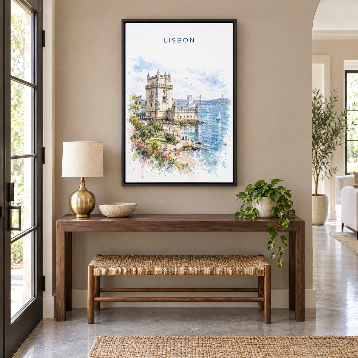 Belém Tower watercolor print as a black floater canvas above a walnut console and woven bench in an entryway