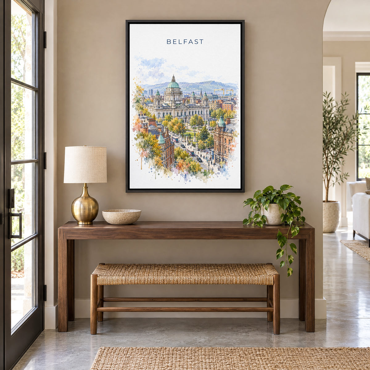 Belfast watercolor print as a black floater canvas above a walnut console and woven bench in an entryway