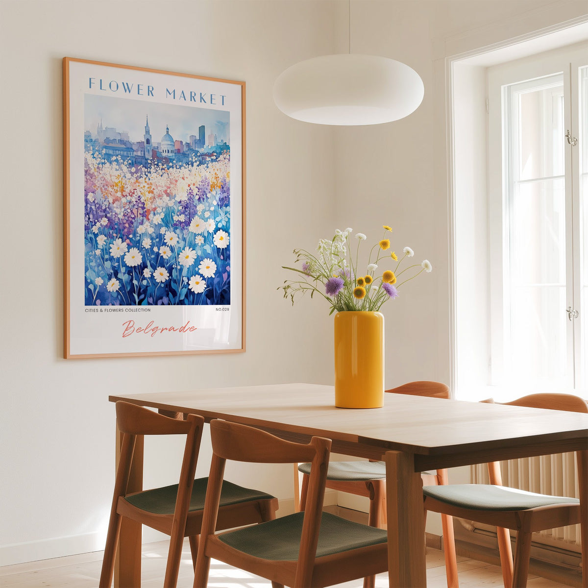 Belgrade flower market print in an oak frame above a dining table with a yellow vase and white pendant light