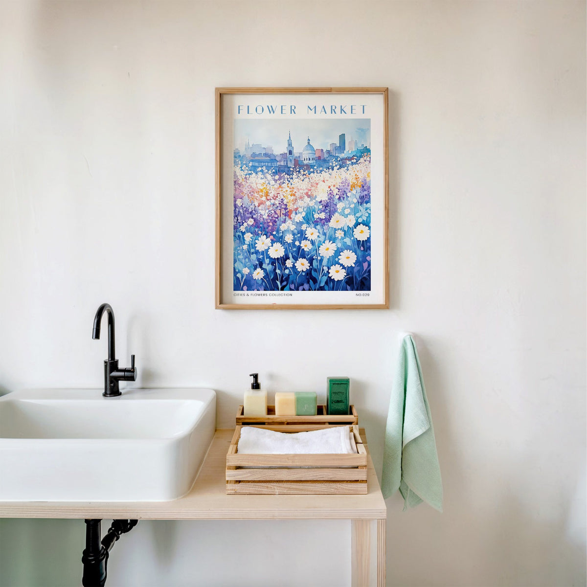 Belgrade flower market print in an oak frame above a white bathroom sink with folded towels