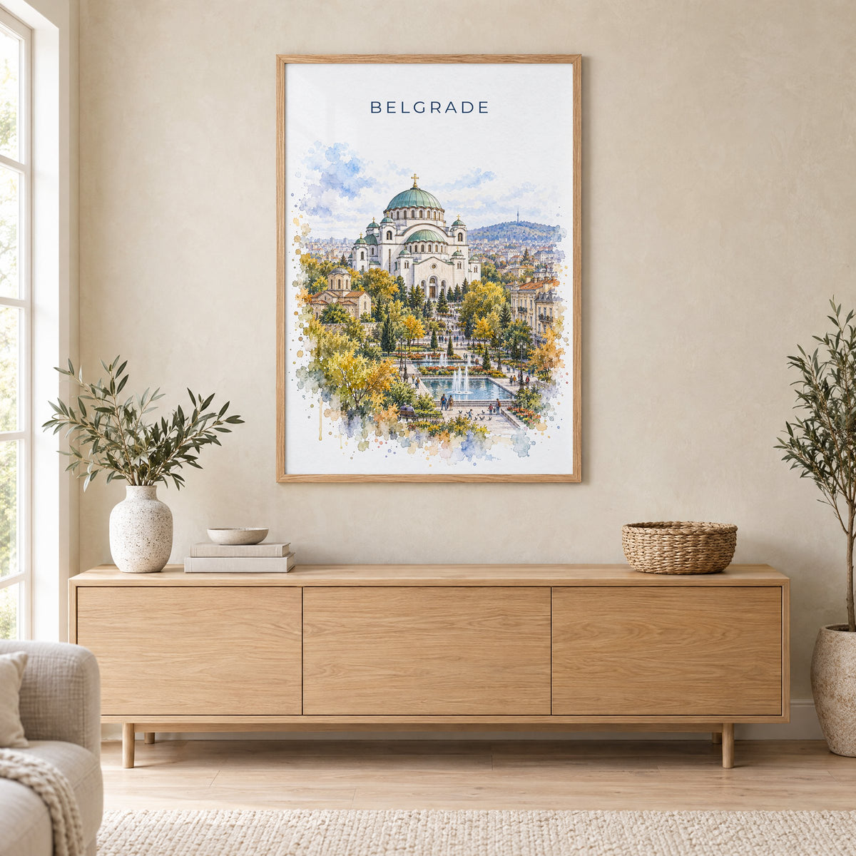 Belgrade watercolor print in an oak frame above a light wood sideboard in a Scandinavian living room