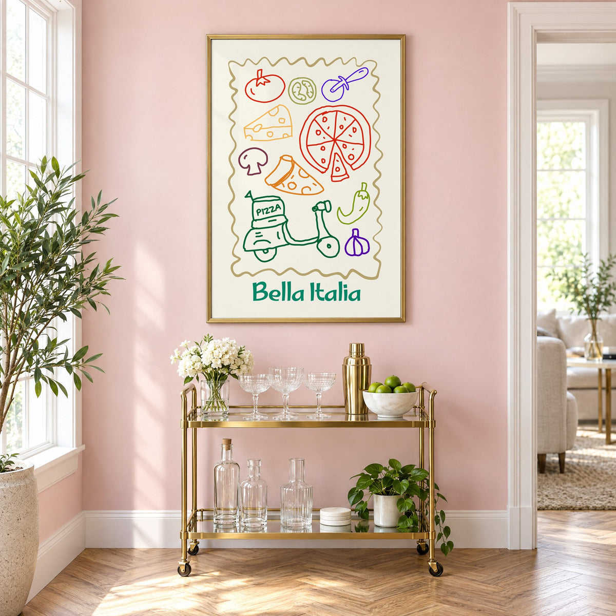 Bella Italia pizza scooter doodle print in a brass frame on a blush pink wall above a gold bar cart with glassware