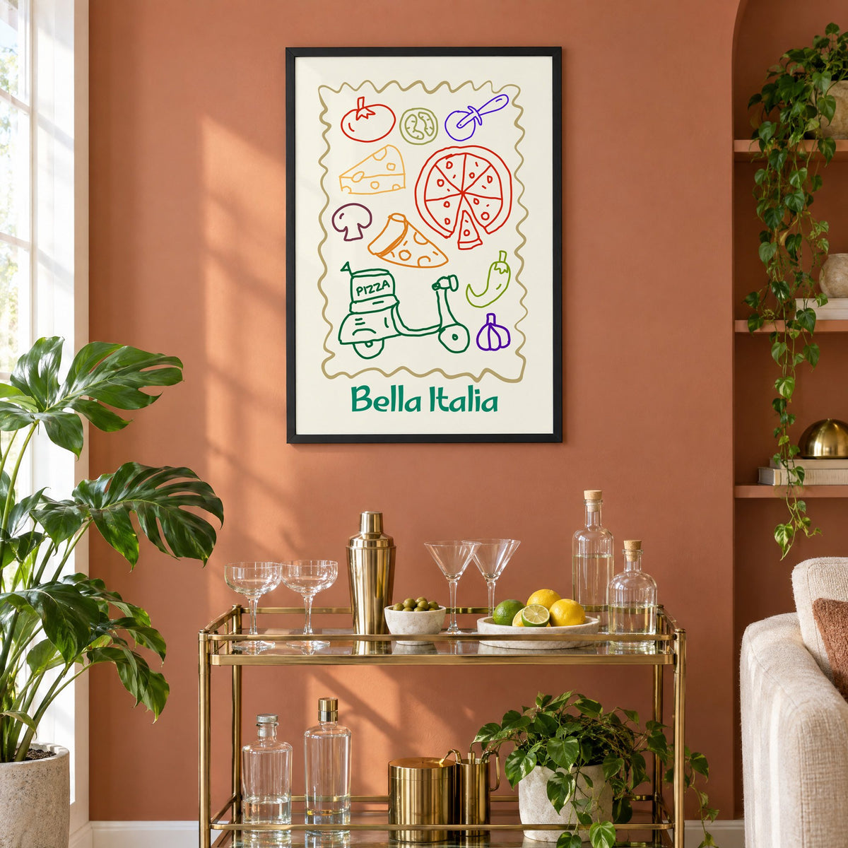Bella Italia pizza scooter doodle print in a black frame on a terracotta wall above a brass bar cart with coupes and citrus
