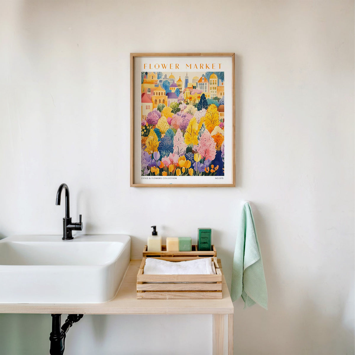 Berlin flower market print in an oak frame above a white bathroom sink with folded towels