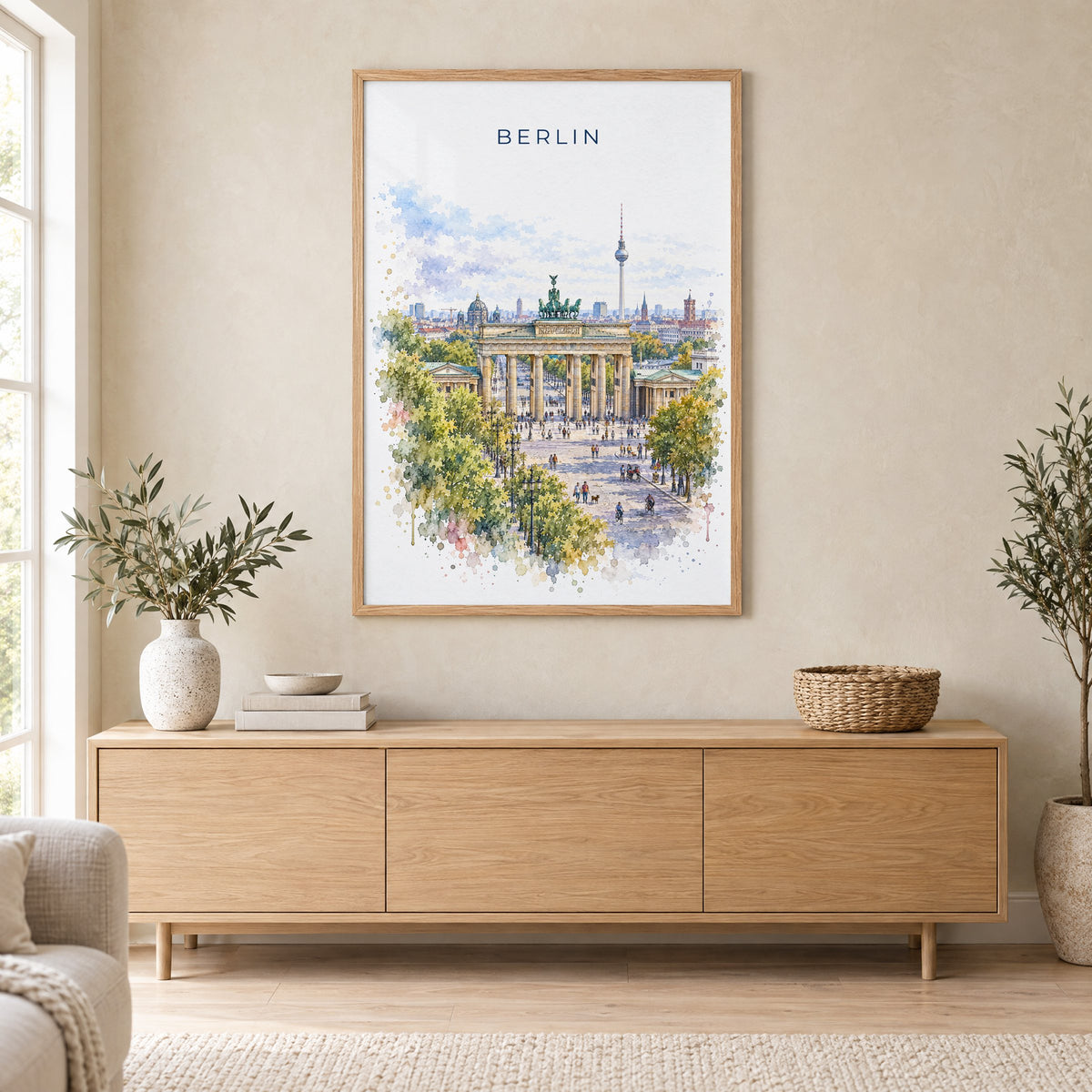 Berlin watercolor print in an oak frame above a light wood sideboard in a Scandinavian living room
