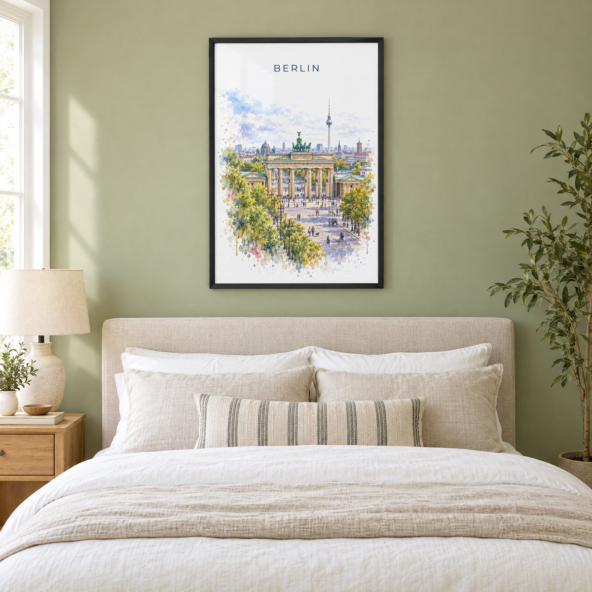 Berlin watercolor print in a black frame above an upholstered headboard in a sage green bedroom