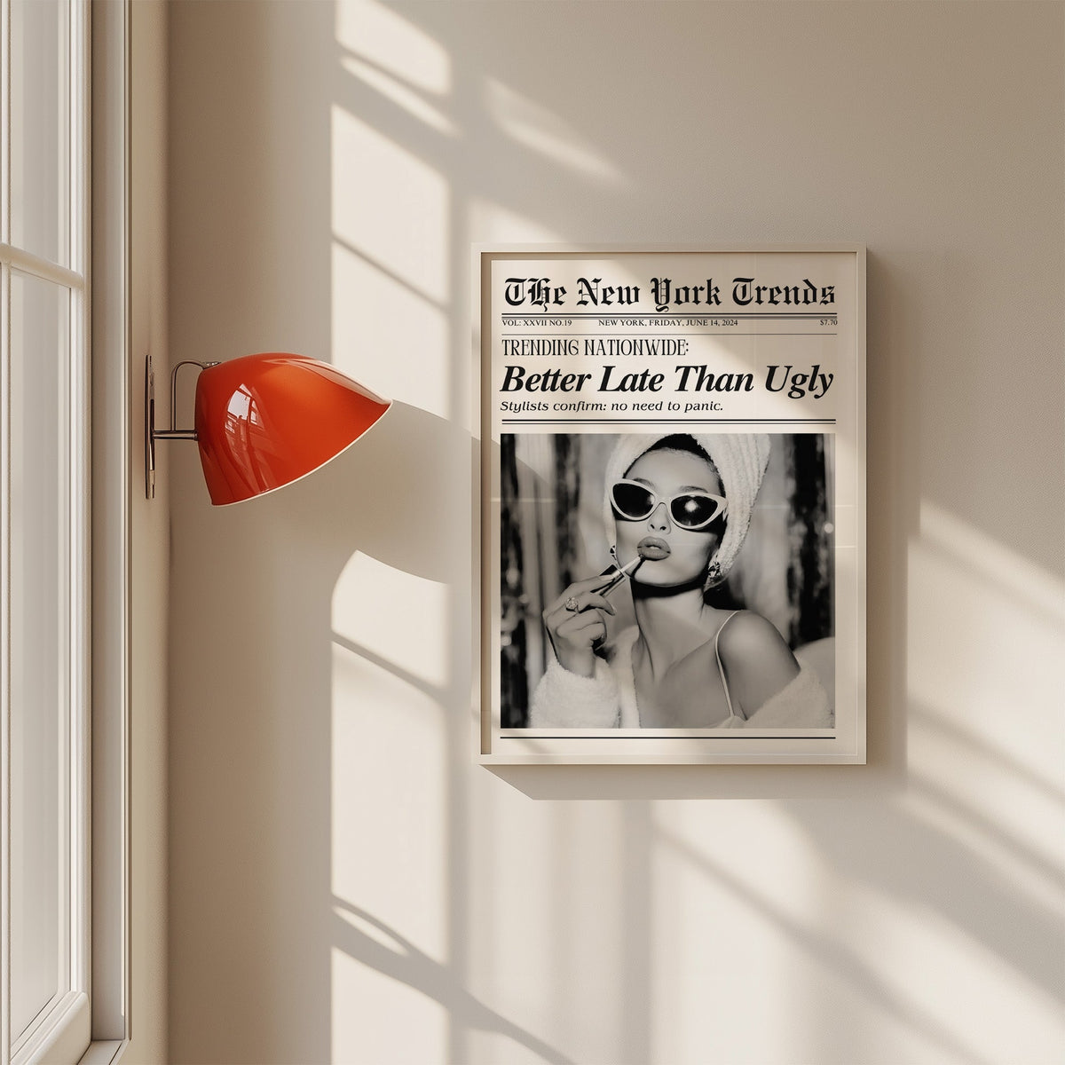 Woman applying lipstick mock newspaper print in a white frame on a sunlit wall beside a red sconce