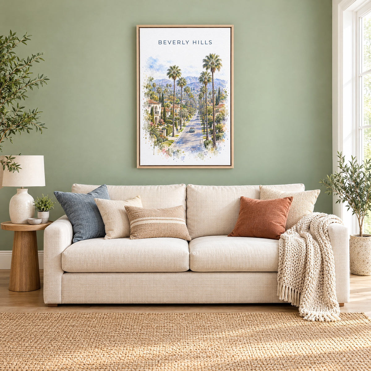 Beverly Hills watercolor print as a natural floater canvas above a cream linen sofa on a sage green wall