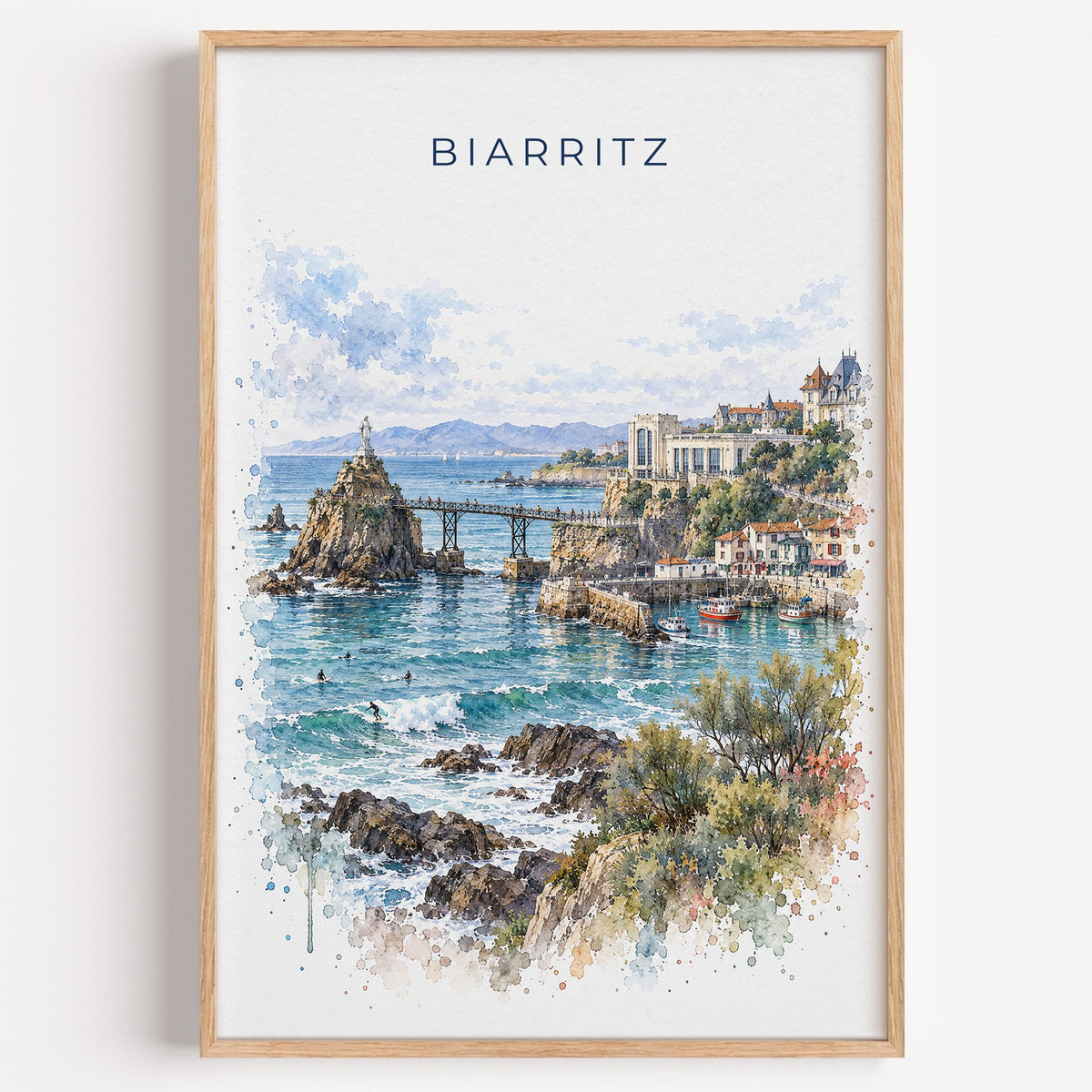 Biarritz watercolor print in a light oak frame on a plain white wall