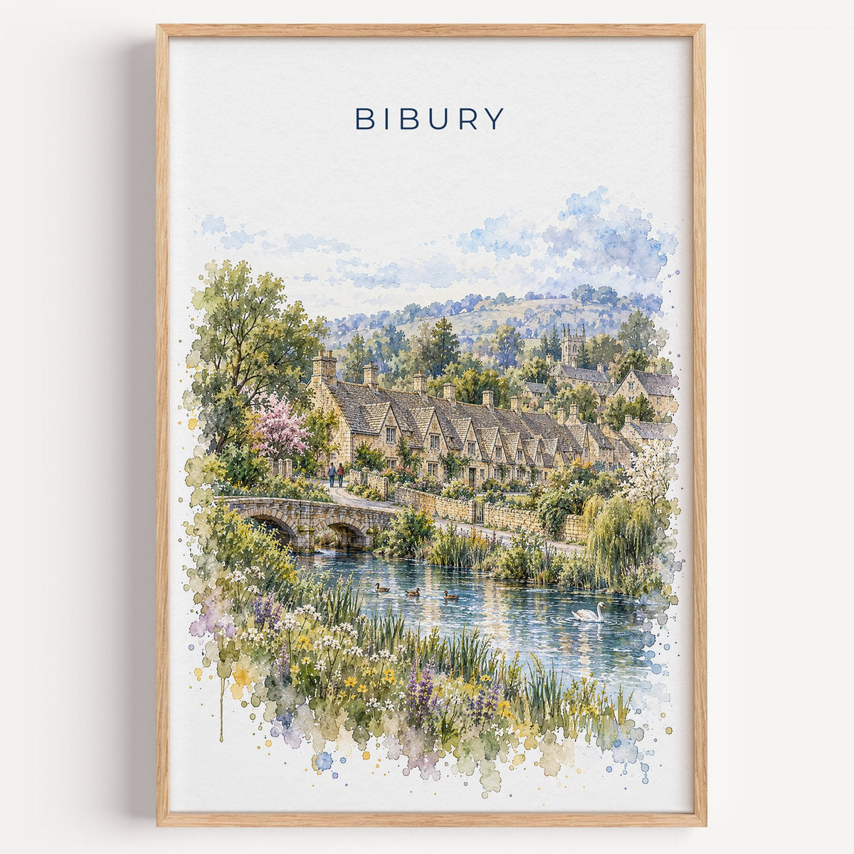 Bibury watercolor print in a light oak frame on a plain white wall