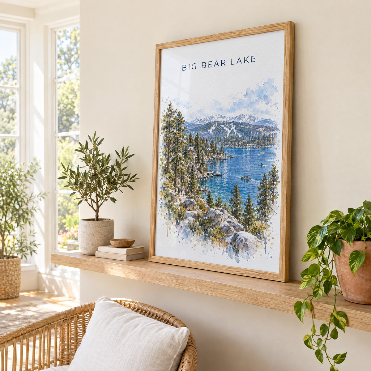 Big Bear Lake watercolor print in an oak frame on a picture ledge in a sunlit sunroom