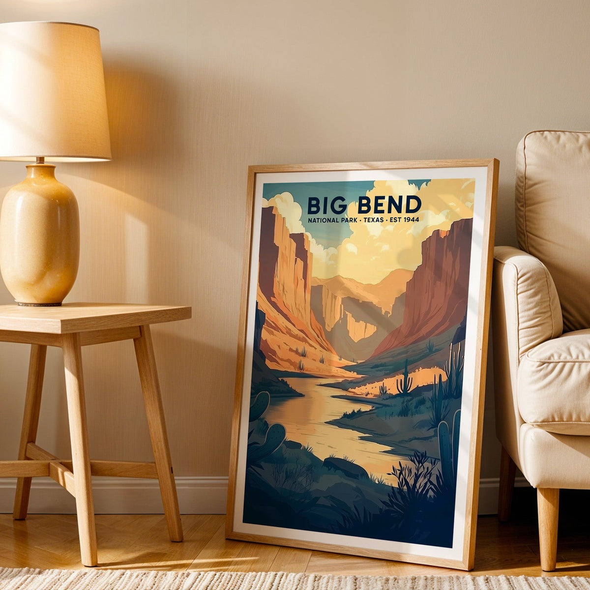 Big Bend print in an oak frame beside a cream armchair and an amber lamp in warm afternoon light