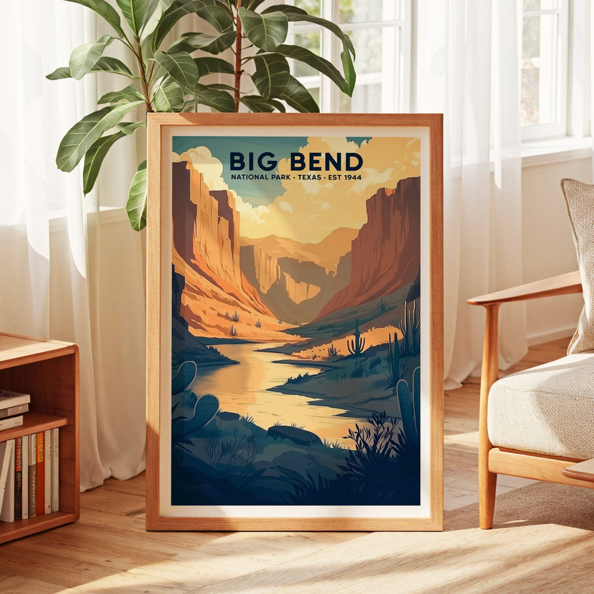 Big Bend National Park print in an oak frame by a sunlit window with sheer curtains and a fig plant