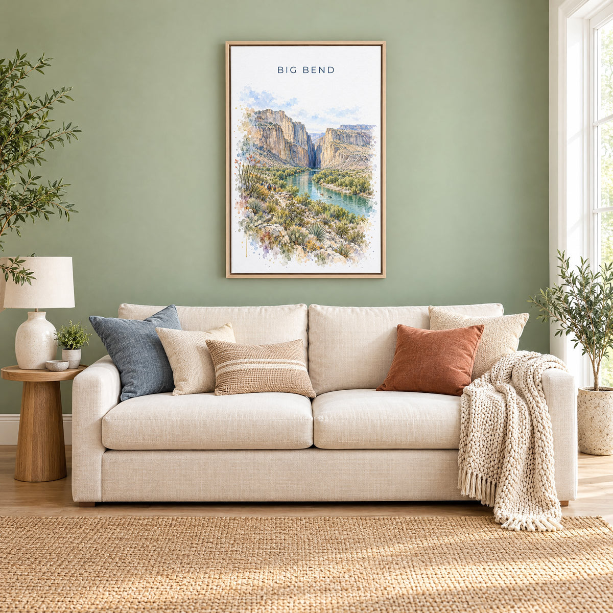 Big Bend National Park watercolor print as a natural floater canvas above a cream linen sofa on a sage green wall
