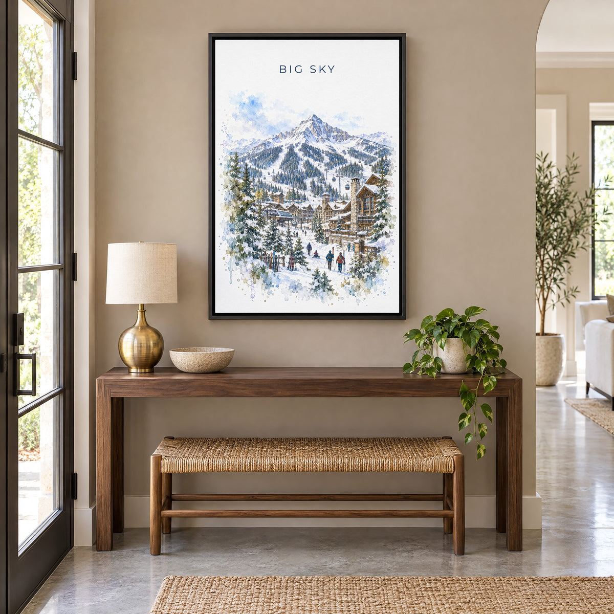 Big Sky watercolor print as a black floater canvas above a walnut console and woven bench in an entryway