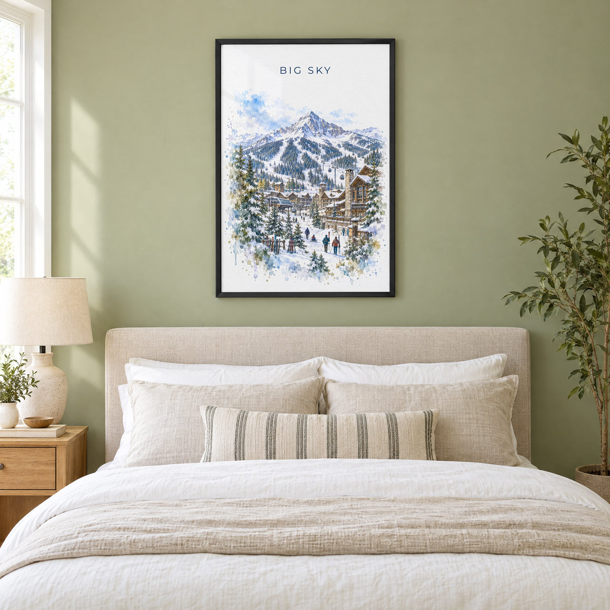 Big Sky watercolor print in a black frame above an upholstered headboard in a sage green bedroom