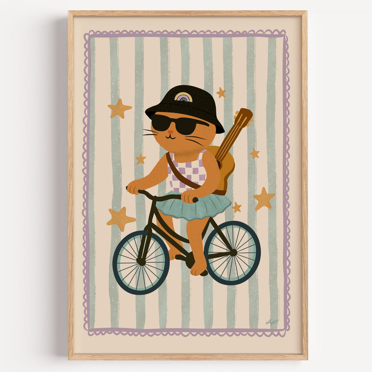 Orange cat on bicycle with ukulele nursery print in a light oak frame on a plain white wall