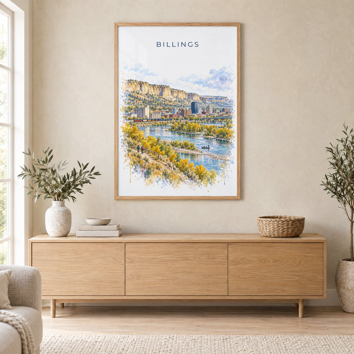 Billings watercolor print in an oak frame above a light wood sideboard in a Scandinavian living room