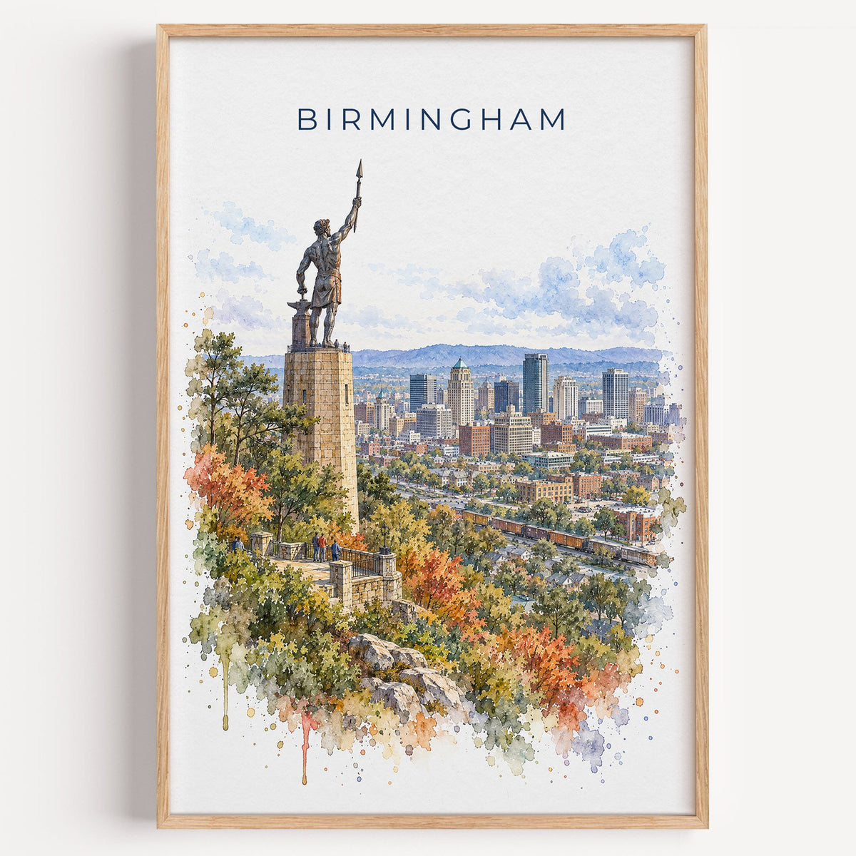 Birmingham, Alabama watercolor print in a light oak frame on a plain white wall