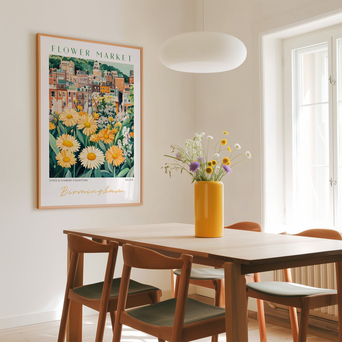 Birmingham flower market print in an oak frame above a dining table with a yellow vase and white pendant light