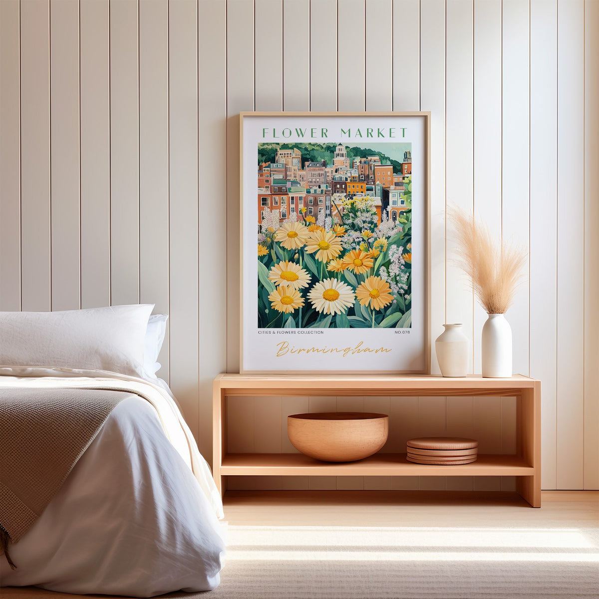 Birmingham flower market print in an oak frame on a wood bench against a white shiplap bedroom wall with pampas grass