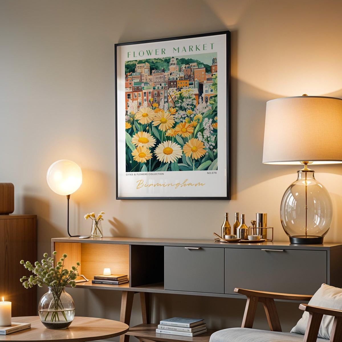 Birmingham flower market print in a black frame above a grey media console with a glass table lamp