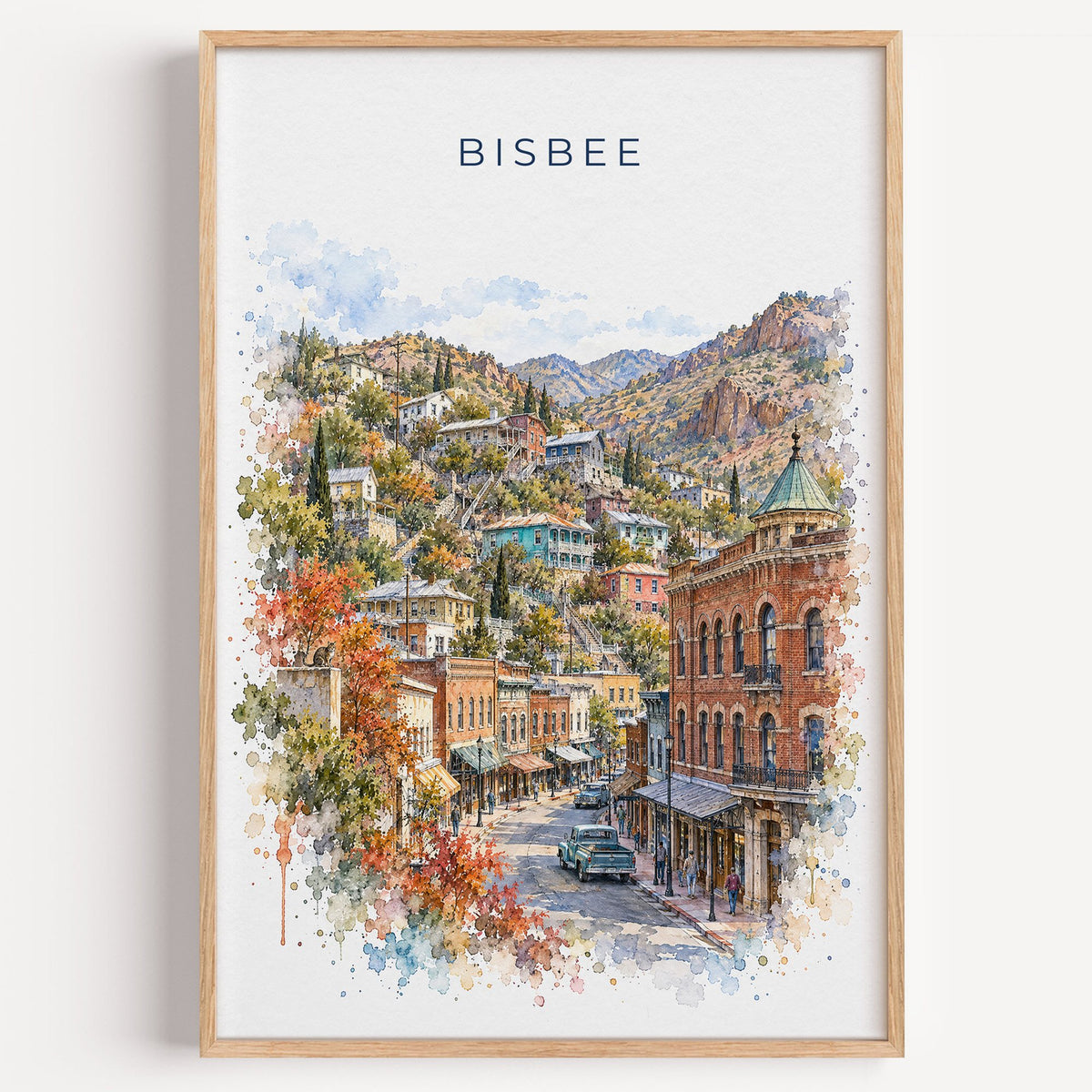 Bisbee watercolor print in a light oak frame on a plain white wall