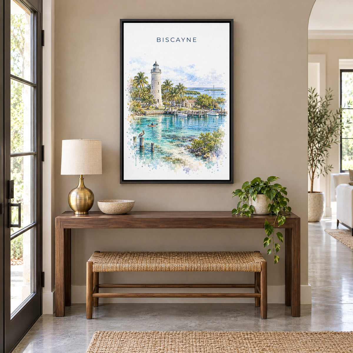 Biscayne National Park watercolor print as a black floater canvas above a walnut console and woven bench in an entryway