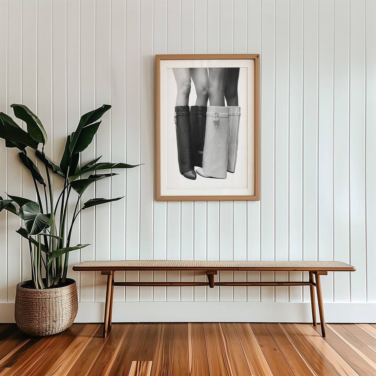 Black and silver crystal knee-high boots print in a wood frame with a white mat above a cane bench