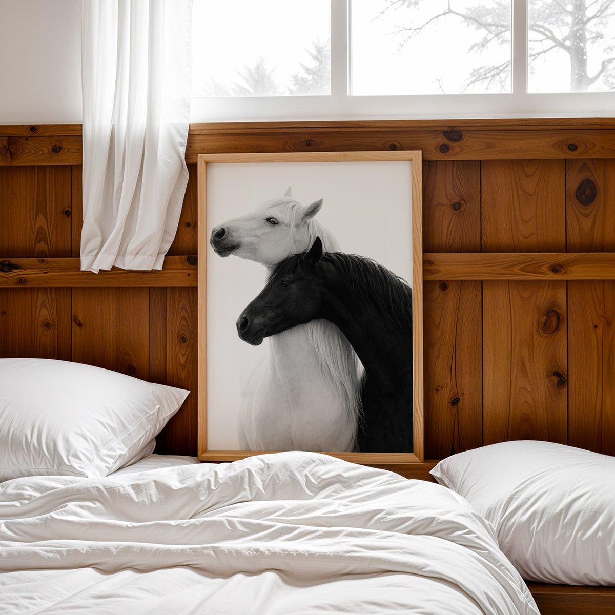 White horse and black horse necks crossed print in a pine frame leaning on a wood headboard over white bedding
