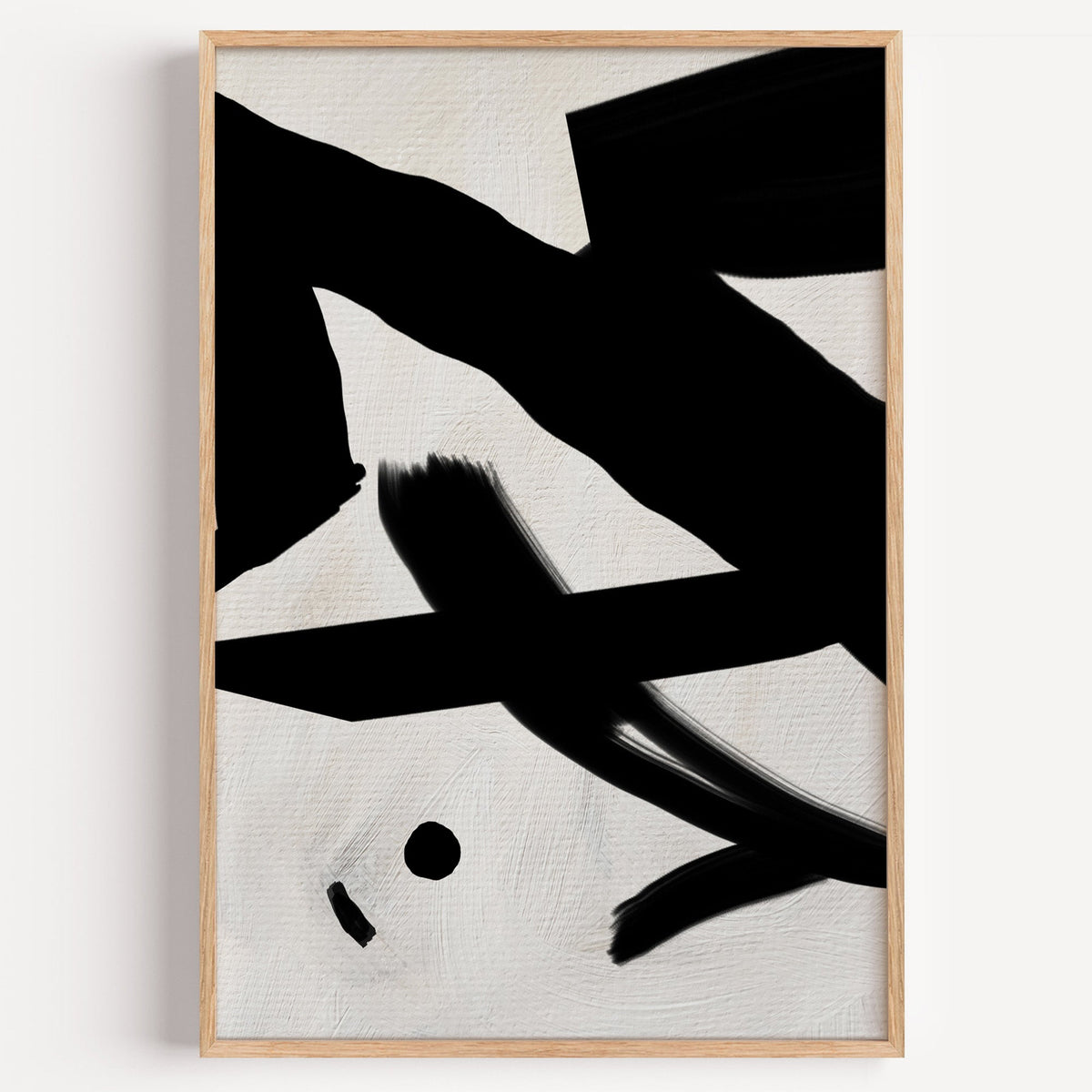 Black bold strokes and dot on cream linen print in a light oak frame on a plain white wall