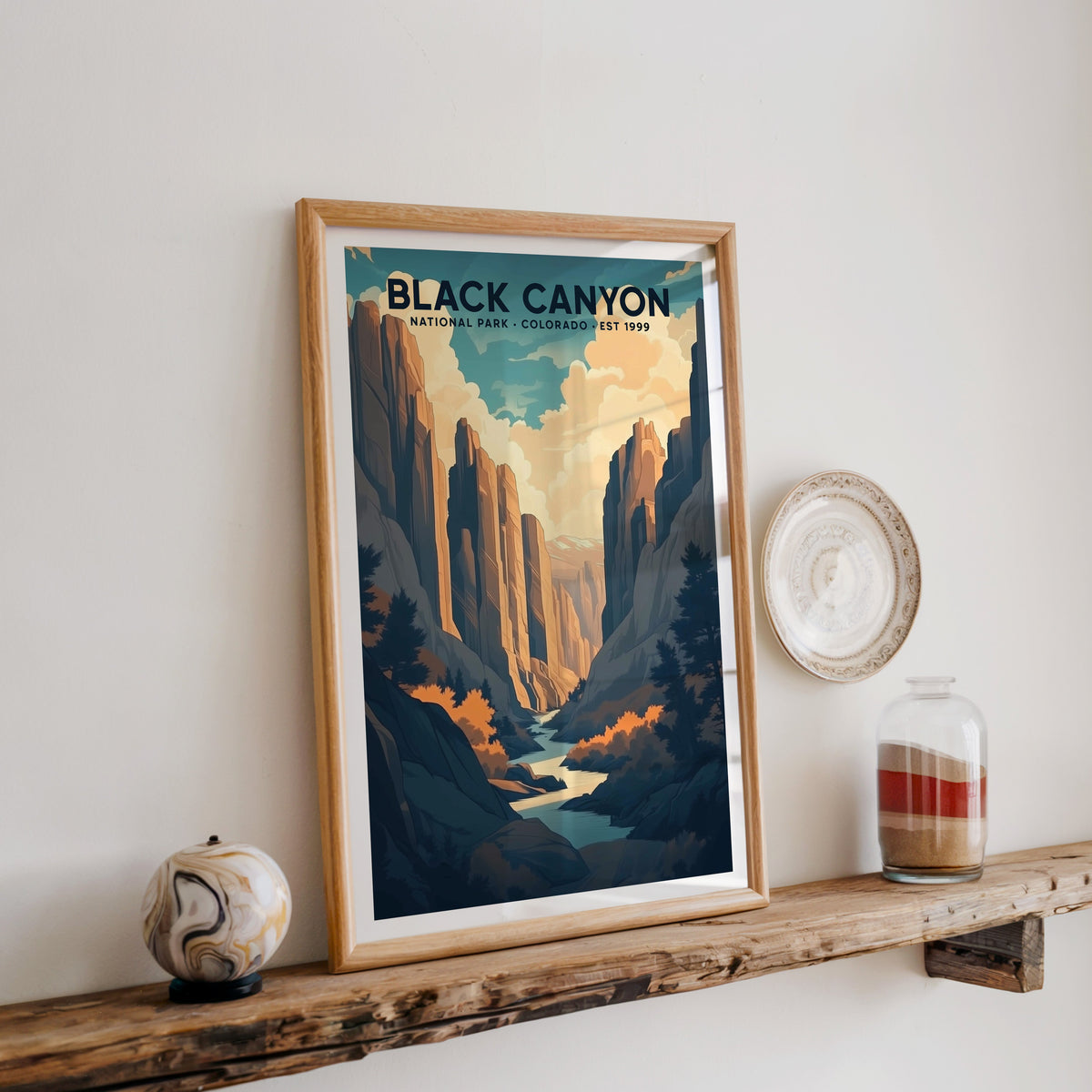 Black Canyon of the Gunnison print in an oak frame on a rustic wood shelf with ceramics