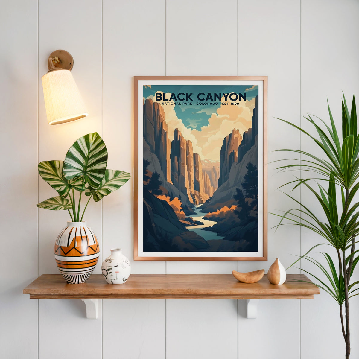 Black Canyon of the Gunnison print in a copper frame above an oak shelf on white shiplap