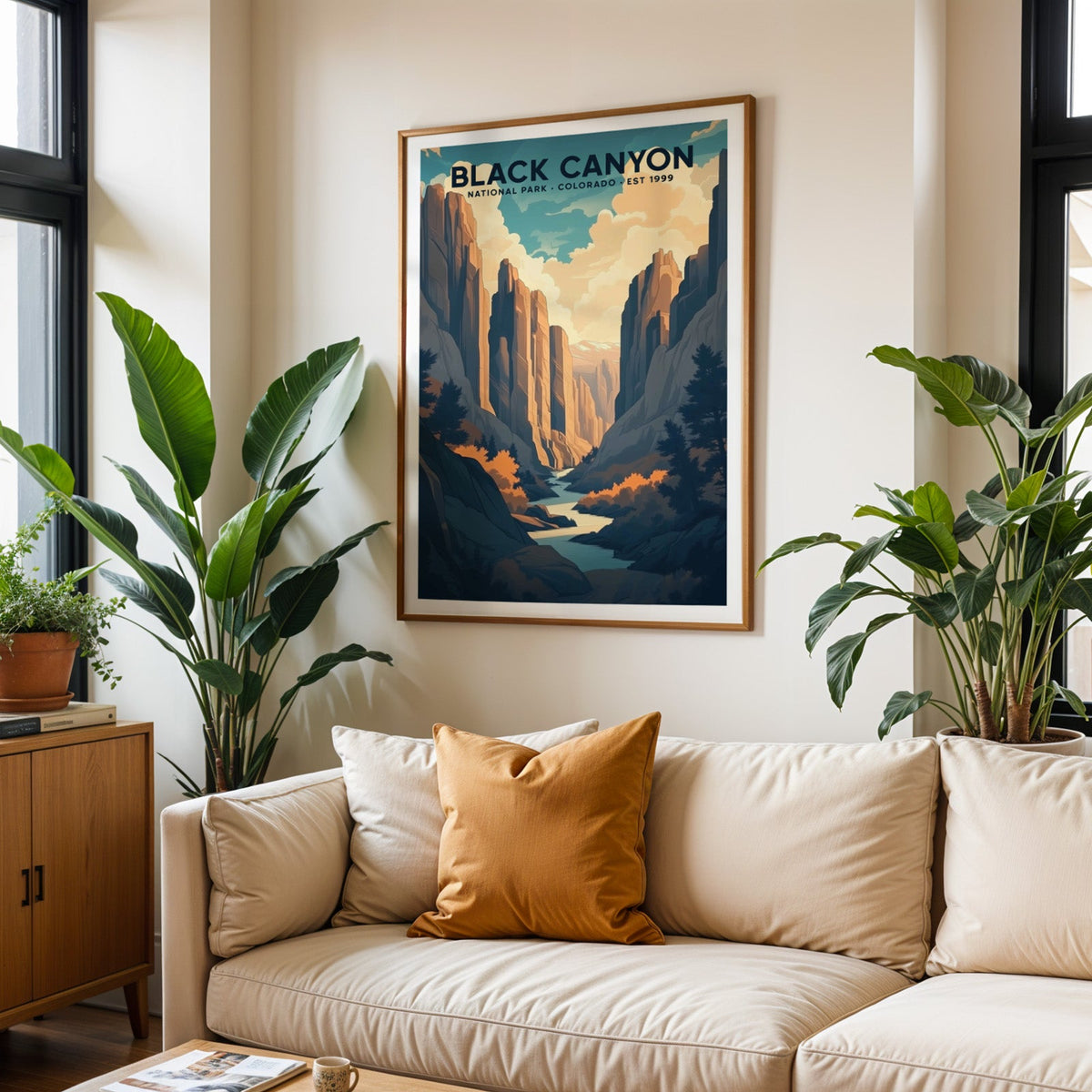 Black Canyon of the Gunnison print in an oak frame above a cream living room sofa