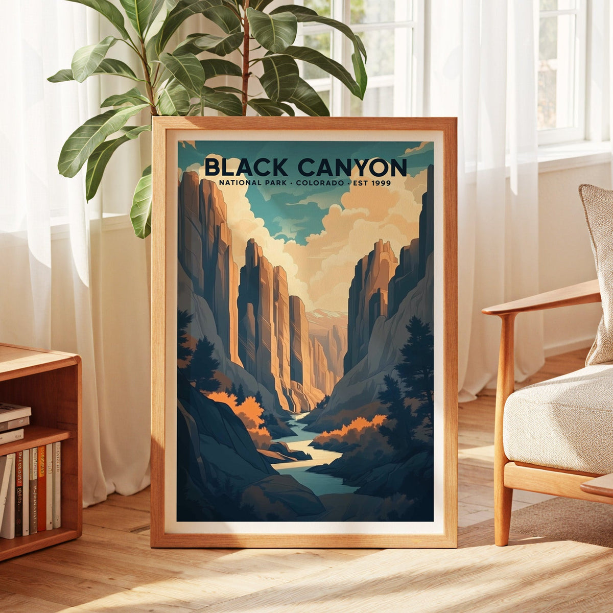 Black Canyon of the Gunnison print in an oak frame by a sunlit window with sheer curtains