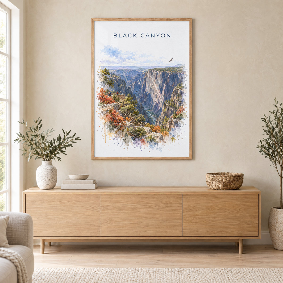Black Canyon of the Gunnison National Park watercolor in an oak frame above a light wood sideboard in a Scandinavian living