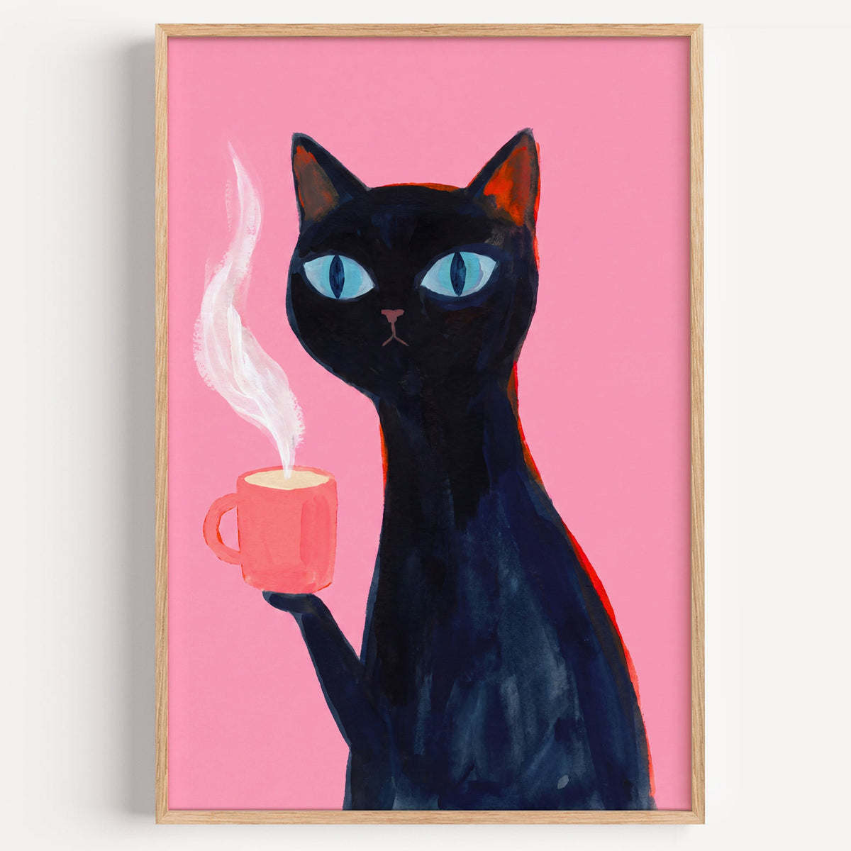 Black cat with pink coffee mug print in a light oak frame on a plain white wall
