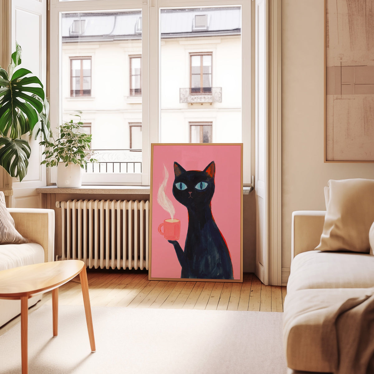 Pink cat coffee print in an oak frame leaning below tall French windows