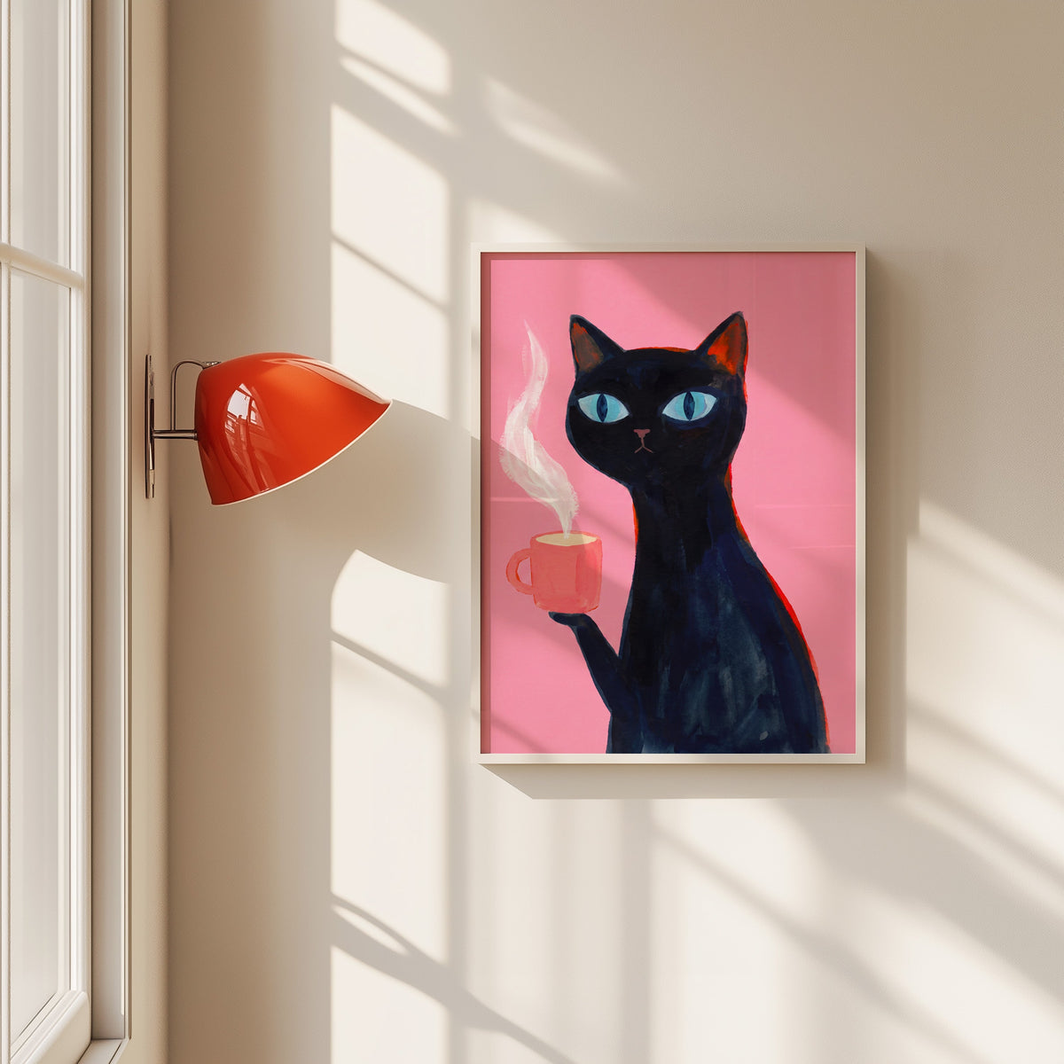 Black cat with pink coffee mug print in a white frame beside a red wall sconce