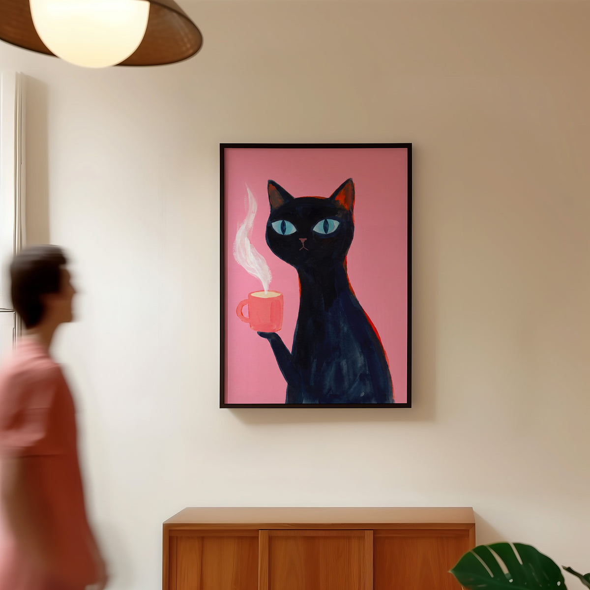 Blue-eyed black cat print in a black frame in a hallway under a rattan pendant