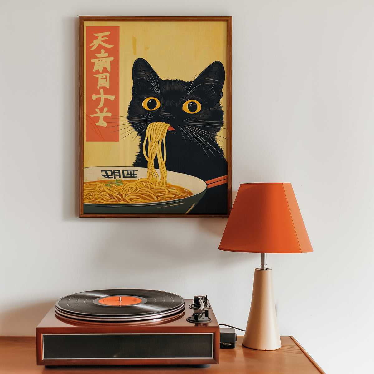 Black cat slurping ramen print in a walnut frame above a sideboard with a record player