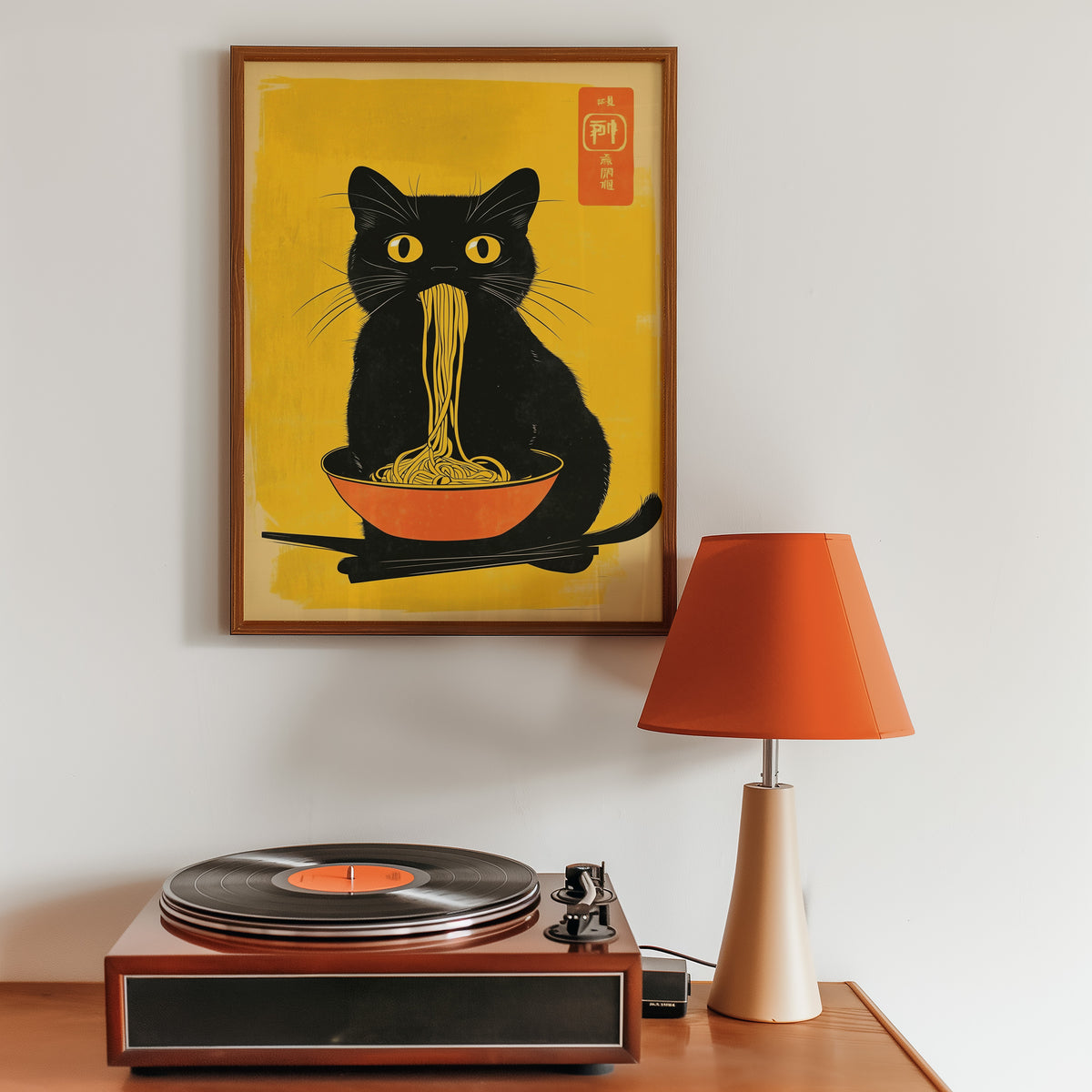 Black cat noodles orange bowl print in a walnut frame above a sideboard with a record player