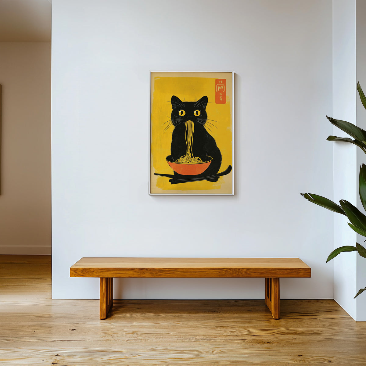 Black cat noodles orange bowl print shown in a white frame above a wooden entryway bench