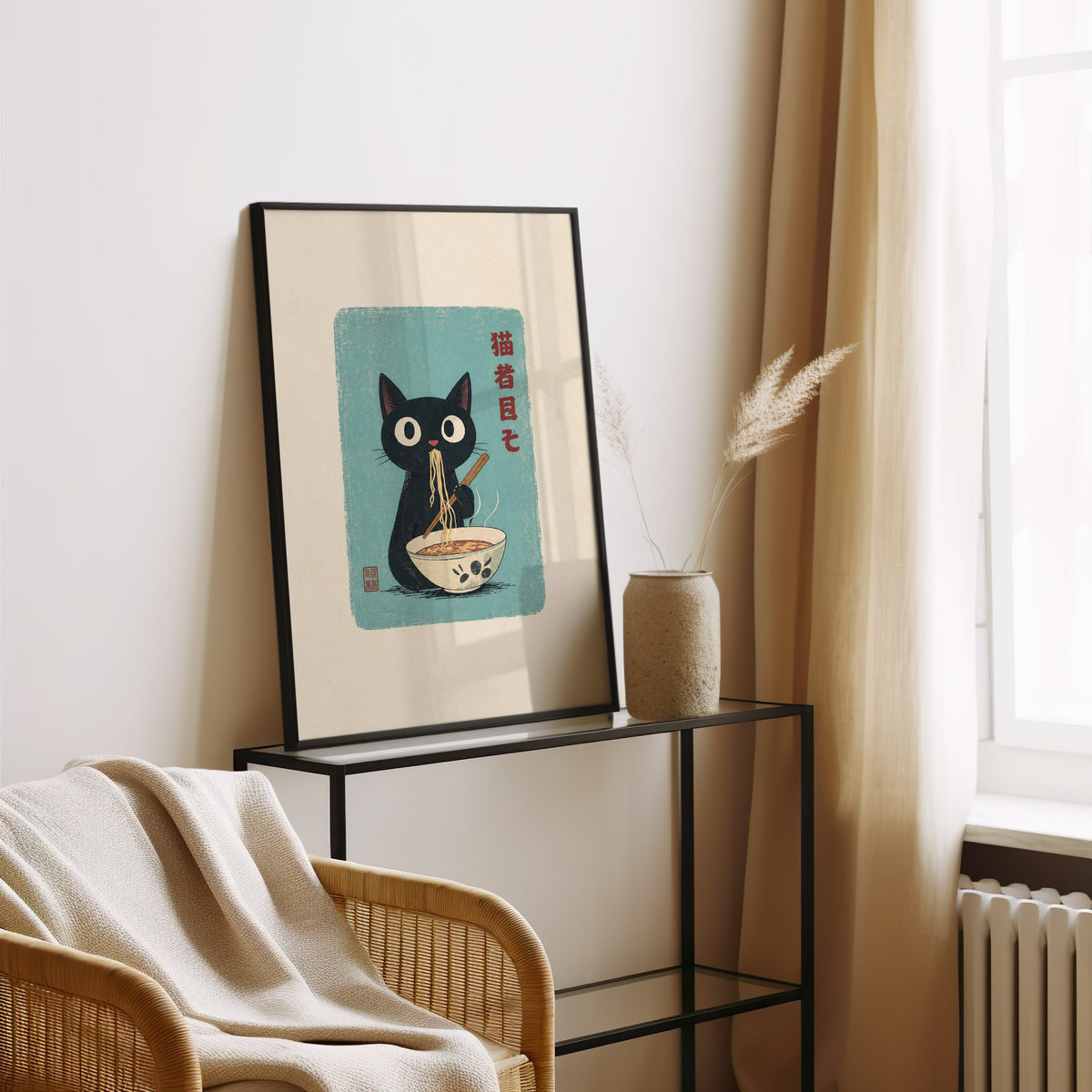 Black cat ramen teal poster in a black frame leaning on a glass console beside pampas grass