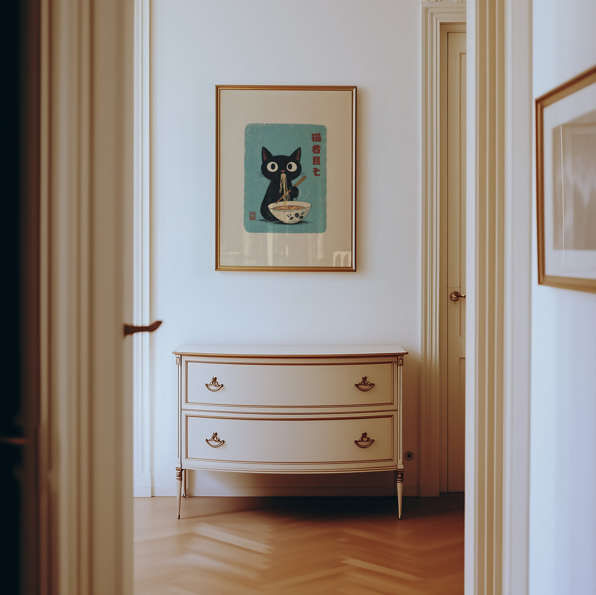 Black cat ramen teal poster shown in a gold frame in a hallway above a cream dresser