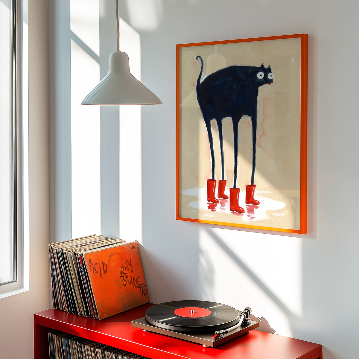 Googly-eyed cat print shown in an orange frame above a red record cabinet and turntable