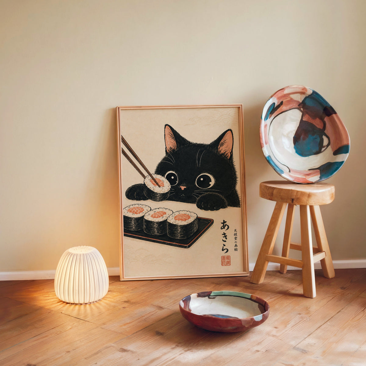 Black cat salmon sushi poster in a light wood frame leaning on a wooden floor by a glowing lamp and stool