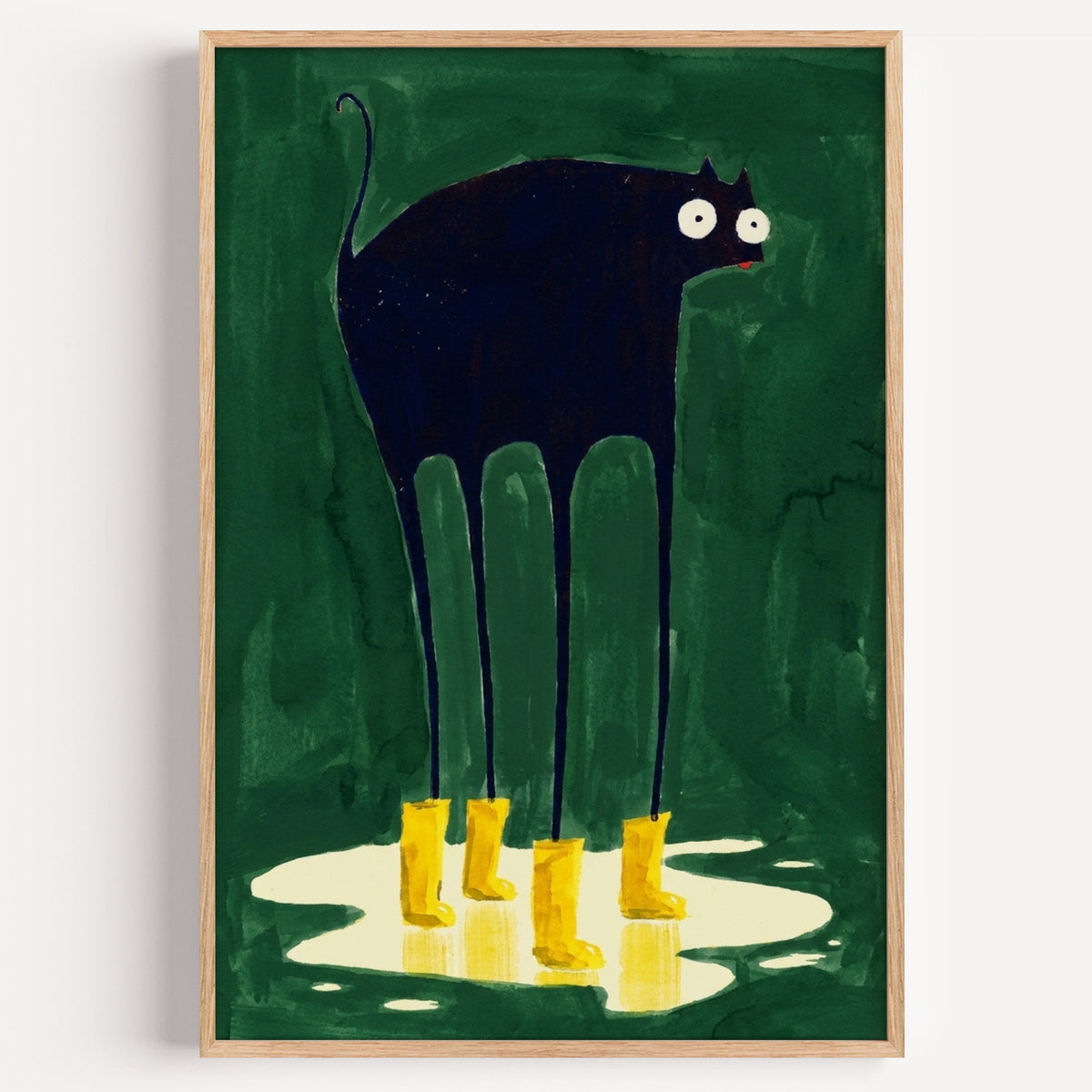 Black cat in yellow rain boots print in a light oak frame on a plain white wall